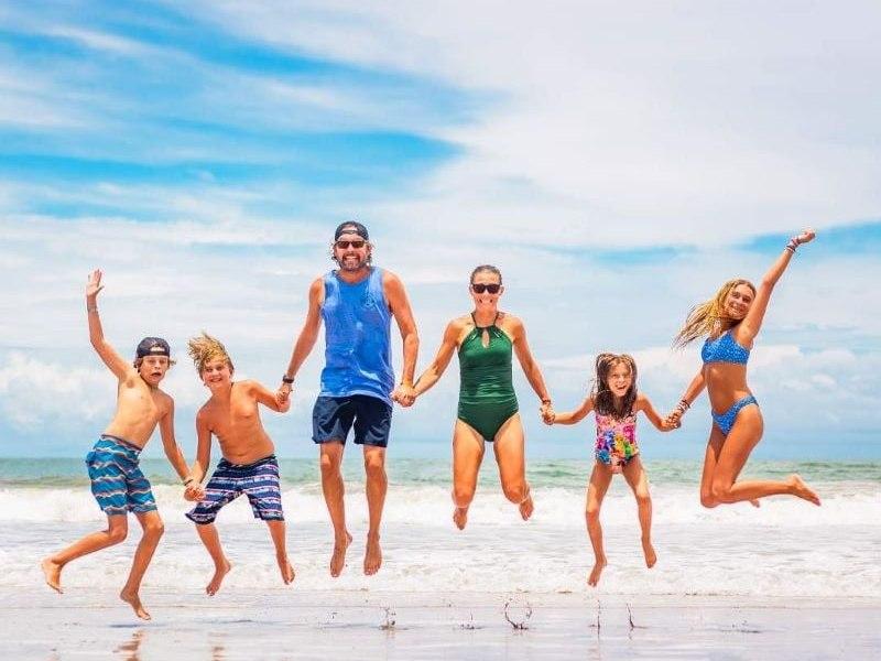 Family jumping on the beach